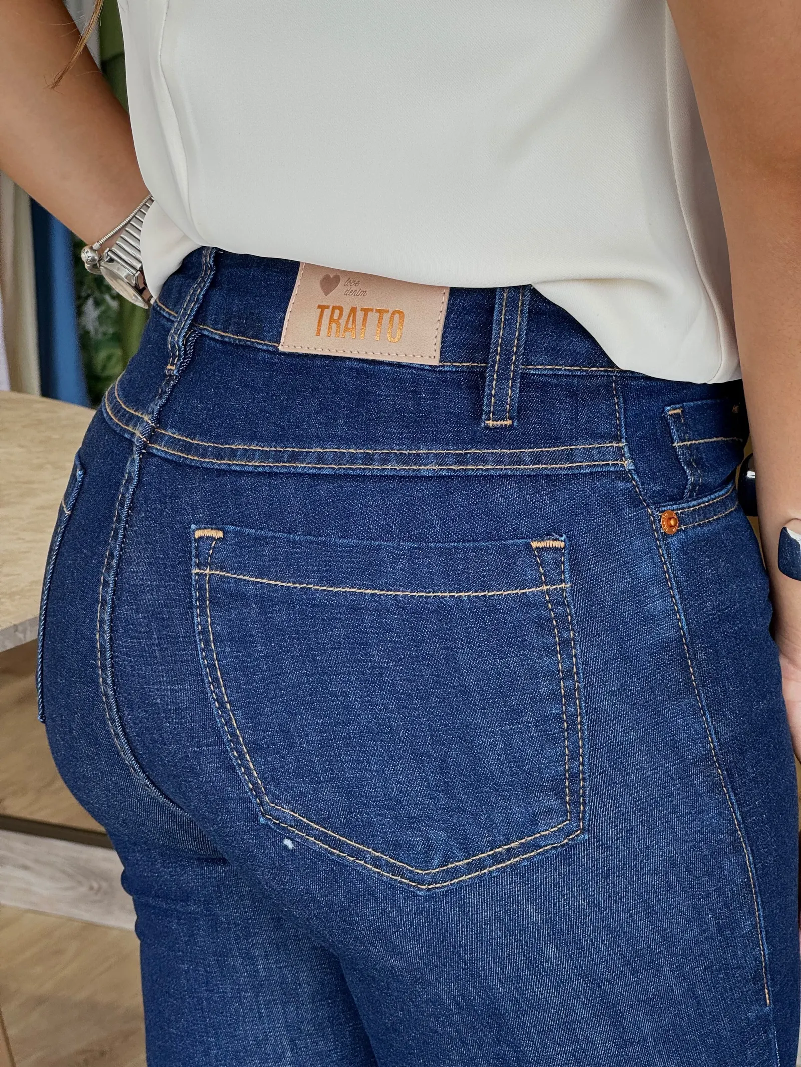 Calça jeans: detalhe do bolso e etiqueta Tratto